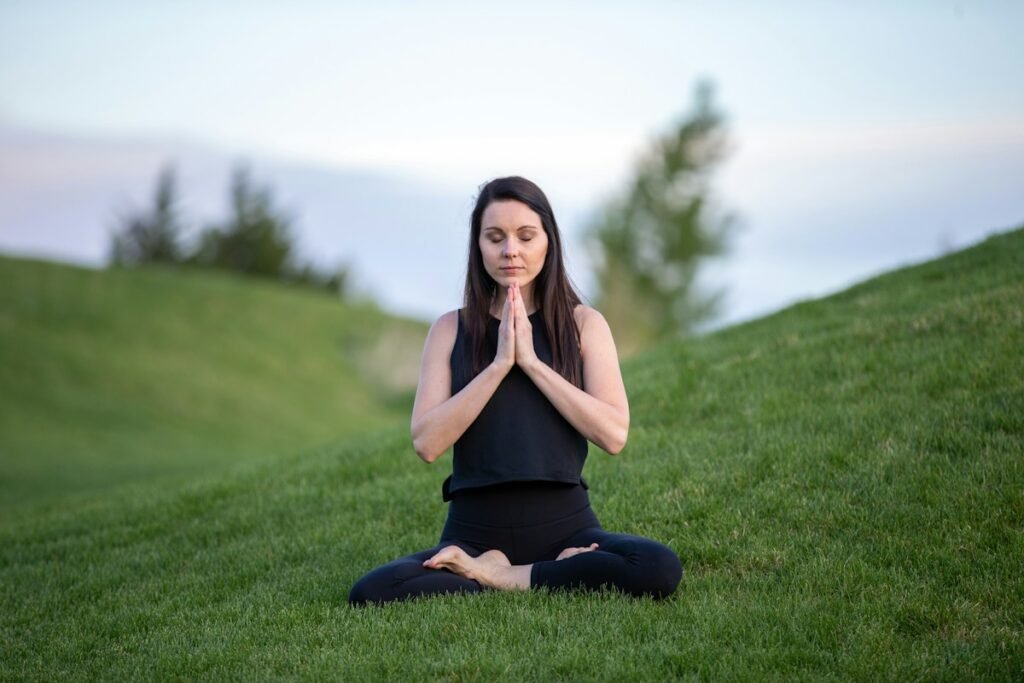 Breathing Exercises to Reduce Anxiety and Improve Lung Capacity Person practicing deep breathing meditation outdoors for stress reduction