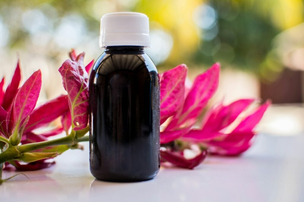 Castor Oil Uses for Hair, Skin and Joint Comfort at Home Castor oil bottle with hair care and skin beauty natural ingredients