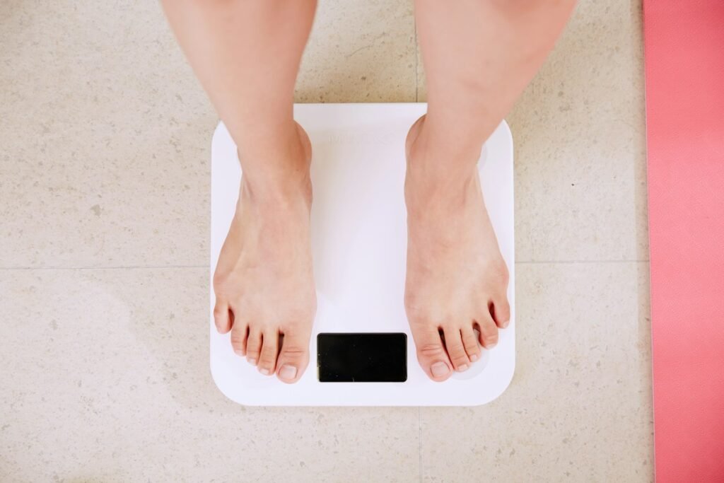 Person with measuring tape showing healthy lifestyle changes for belly fat loss